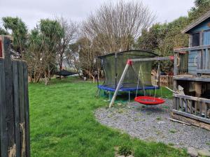a playground in a yard next to a house at An Tigin in Cahersiveen