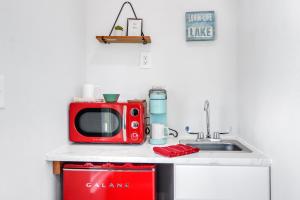 a kitchen with a red microwave and a sink at The Container Retreat - 3B in Canyon Lake