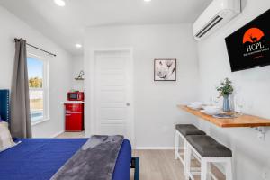a bedroom with a bed and a desk and a table at The Container Retreat - 3B in Canyon Lake