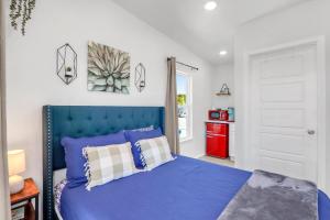 a bedroom with a blue bed and a red cabinet at The Container Retreat - 3B in Canyon Lake
