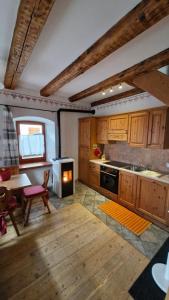 a kitchen with wooden cabinets and a stove top oven at Casa di Chiara in Padola