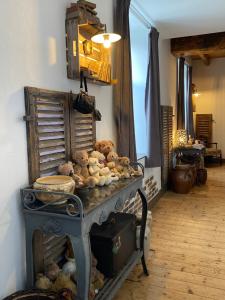 a bunch of stuffed animals sitting on a table at Le Moulin de Visargent in Sens sur Seille
