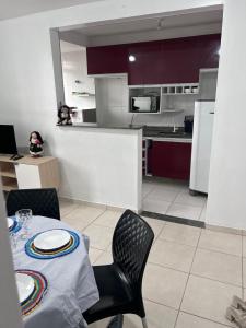 a kitchen with a table and two chairs and a kitchen with a table andktop at Aconchegante apartamento Sinta-se em Casa in Belém