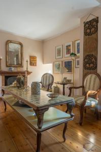 a living room with a table and chairs and a fireplace at Acropolis Villa in Plaka in Athens