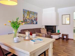 a living room with a table and a couch at Apartment Vico Morcote Luxury View Apartment by Interhome in Morcote