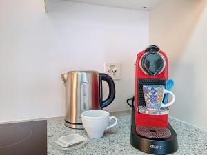 a red coffee maker and a cup on a counter at Apartment Vico Morcote Luxury View Apartment by Interhome in Morcote +21 photos