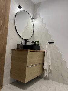 a bathroom with a sink and a mirror on a vanity at Skyframe Cabin in Pucheni