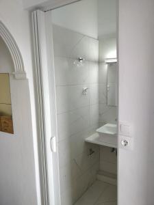 a white bathroom with a sink and a shower at Thaleia Studios & Apartments in Kavos +18 photos