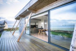 an open balcony with a view of the ocean at Jog Lodge 13 By Together Travel - 3 Bed in John O Groats