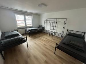 an empty room with two beds and a window at Monteurswohnung Schwarzwald in Eggingen