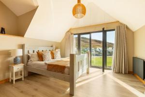 a bedroom with a bed and a large window at 5 Bed in Mortehoe oc-c30855 in Mortehoe