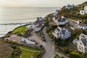 an aerial view of houses on a hill next to the ocean at 5 Bed in Mortehoe oc-c30855 in Mortehoe