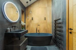 a bathroom with a blue tub and a sink at 5 Bed in Mortehoe oc-c30855 in Mortehoe +36 photos