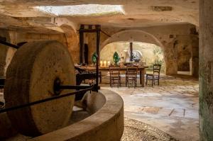 a large stone room with a table and chairs at Masseria Buganvillea in Fasano