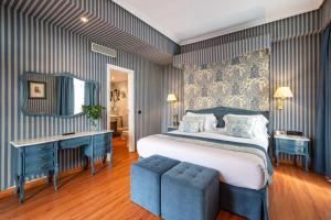 a bedroom with a bed and a desk and a mirror at Agumar Atocha in Madrid +56 photos