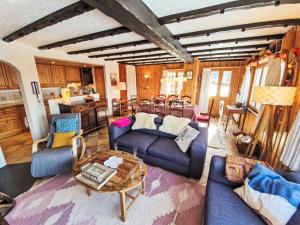a living room with couches and a table at Chalet Chalet Le Rhônasson by Interhome in Vercorin