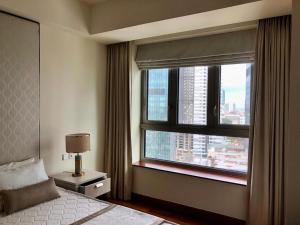 a bedroom with a window with a view of a city at Cinnomon Life Residence Tower 20 3 in Colombo +36 photos