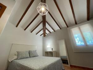 a bedroom with a bed and a ceiling with a chandelier at Villa con piscina y barbacoa en Calpe in Calpe +36 photos