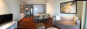 a living room with a couch and a dining room at Cinnomon Life Residence Tower 20 3 in Colombo