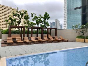 a pool with chairs and a gazebo next to a pool at Cinnomon Life Residence Tower 20 3 in Colombo