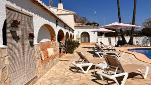a patio with lounge chairs and a swimming pool at Villa con piscina y barbacoa en Calpe in Calpe