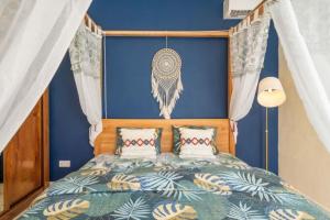 a bedroom with a bed with a blue wall at Balaclava Star Villa in Balaclava +21 photos