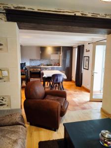 a living room with a couch and a table at Petite parenthèse au gîte Layon in Les Garennes sur Loire