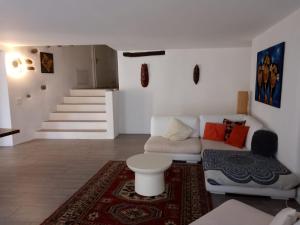 a living room with a couch and a staircase at Casa Edo in Ponte Tresa