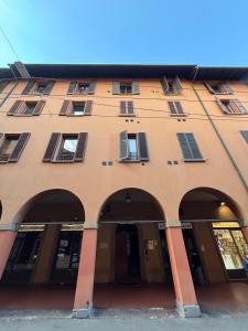 a large building with arches in front of it at Da Lorenzo Luxury Apartment in Bologna
