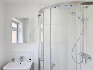 a white bathroom with a shower and a sink at Orchard Mews , Barnham in Barnham +22 photos