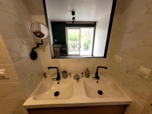 a bathroom with a sink and a mirror at Villa Palama in Marseille +12 photos