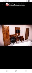 a room with a desk with a computer and a chair at hotel kargil inn in Satna