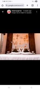 a page of a website with a picture of a bed at hotel kargil inn in Satna