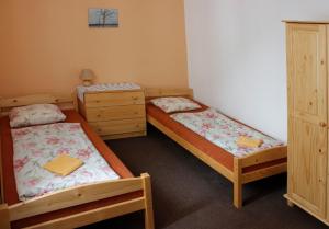 a room with two beds and two dressers at Apartmány Amaris in Strachotín