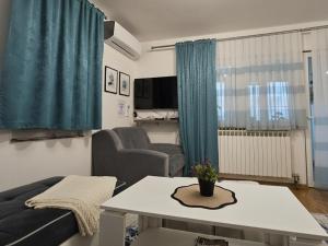 a living room with a couch and a table at Sarajevo Central View Apartment in Sarajevo