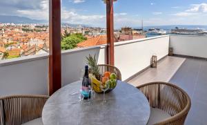 a table with a bowl of fruit on a balcony at Apartment AURELIUS - Panoramic Views - City Center - Marjan Park - Quiet in Split