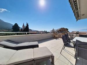 a patio with a couch and chairs on a roof at Apartment Rilić-3 by Interhome in Zaostrog
