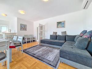 a living room with a couch and a table at Apartment Rilić-3 by Interhome in Zaostrog