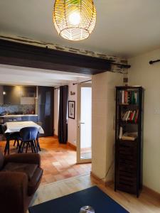 a living room with a couch and a table at Petite parenthèse au gîte Layon in Les Garennes sur Loire