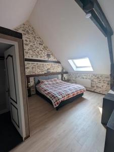 a bedroom with a bed in a attic at Chambres des Gatinelles in Erbray
