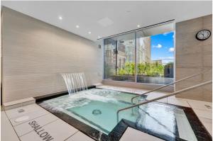 a hot tub in a room with a window at Traveller home in centre Toronto in Toronto
