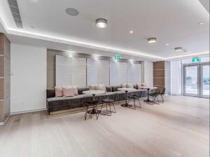 a large room with a couch and tables and chairs at Traveller home in centre Toronto in Toronto +36 photos