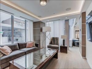 a living room with a couch and a glass table at Traveller home in centre Toronto in Toronto