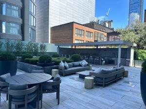 a patio with couches and tables and a building at Traveller home in centre Toronto in Toronto