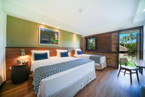 a large bedroom with a large bed and a desk at Salinas Maragogi All Inclusive Resort in Maragogi