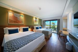 a hotel room with two beds and a window at Salinas Maragogi All Inclusive Resort in Maragogi +60 photos