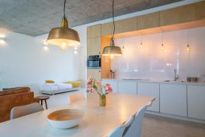 a kitchen with a table with a vase of flowers on it at Houthaven Apartments in Amsterdam