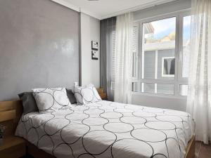 a bedroom with a large bed and a window at Casa El Robledal 5925 in Arnuero