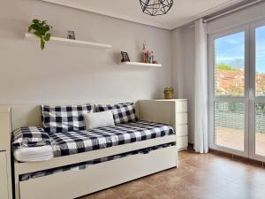 a white room with a couch and a window at Casa El Robledal 5925 in Arnuero