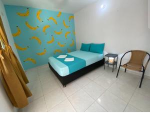 a bedroom with a bed with bananas on the wall at Tamarindo in Santa Marta